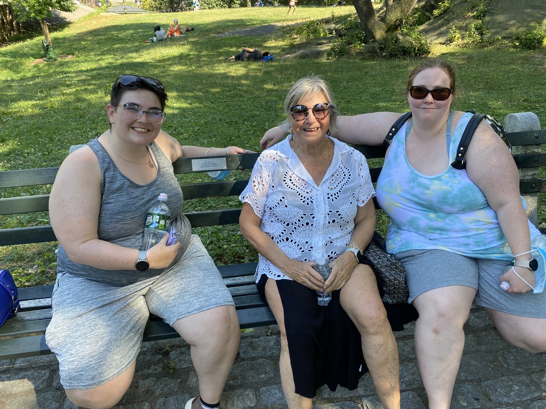 Bunny sitting with two visitors at her bench
