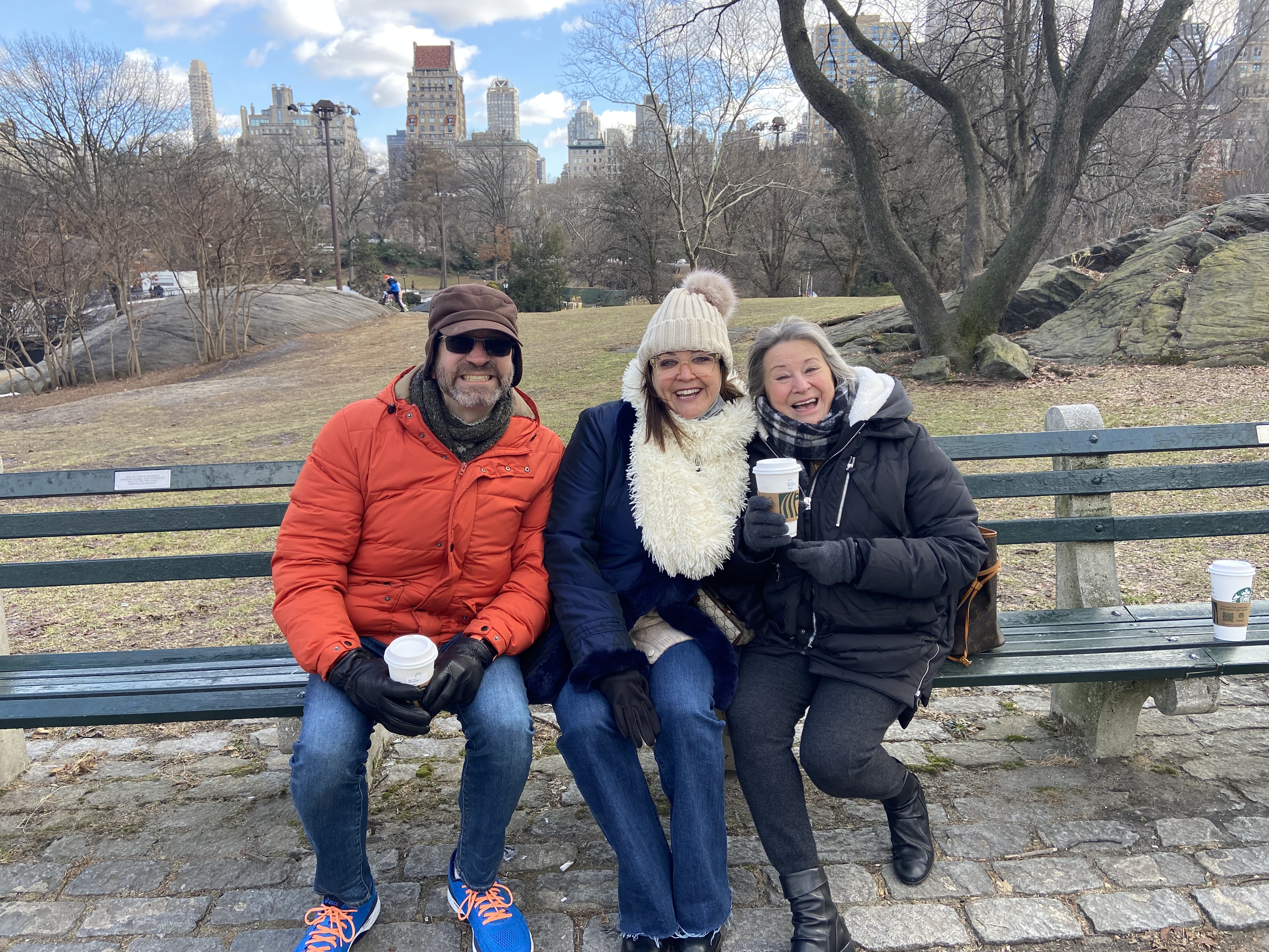Three family members enjoying a winter visit to Bunny's bench